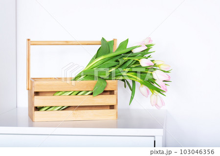 Bouquet of pink tulips in a wooden box 103046356