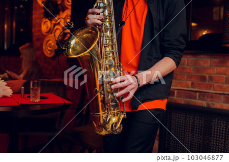 International jazz day and World Jazz festival. Saxophone, music instrument played by saxophonist player musician in fest. International jazz day and World Jazz festival. Saxophone, music instrument played by saxophonist player musician in fest. 103046877