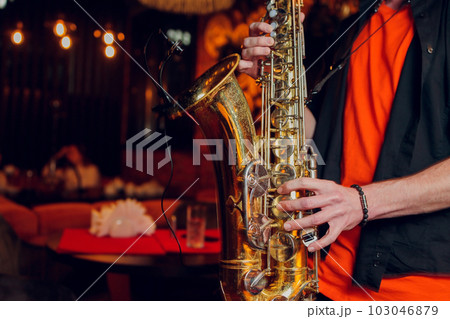 International jazz day and World Jazz festival. Saxophone, music instrument played by saxophonist player musician in fest. International jazz day and World Jazz festival. Saxophone, music instrument played by saxophonist player musician in fest. 103046879