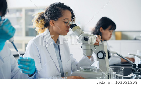 研究室で実験する多国籍研究者グループ 103051598