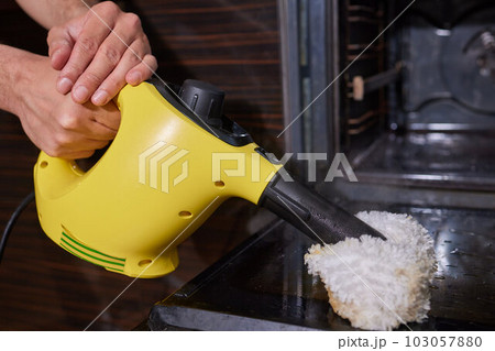 Premium Photo  Steam cleaning oven house cleaning hand close-up.