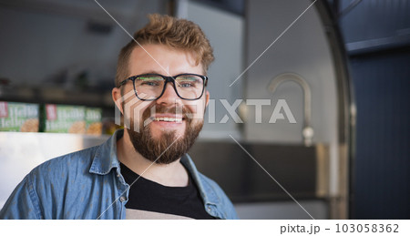 Portrait of young creative entrepreneur smiling in modern workplace copy space - Bearded millennial freelancer man in office Portrait of young creative entrepreneur smiling in modern workplace copy space - Bearded millennial freelancer man in office 103058362