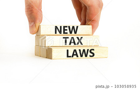 New tax laws symbol. Concept words New tax laws on wooden blocks on a beautiful white table white background. Businessman hand. Business new tax laws concept. Copy space. 103058935