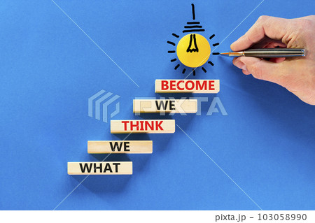 We become or think symbol. Concept word What we think We become on wooden block. Beautiful blue table blue background. Businessman hand. Business we become or think concept. Copy space. 103058990
