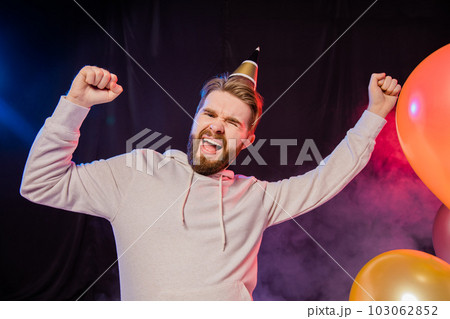 Joyful bearded man celebrates something happy playful mood and winner raises fists. Party time and holiday concept Joyful bearded man celebrates something happy playful mood and winner raises fists. Party time and holiday concept 103062852