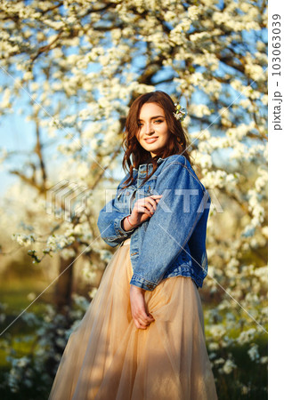 Portrait of a beautiful bride. Wedding concept. Stylish wedding. Great sunset light. Spring garden. 103063039