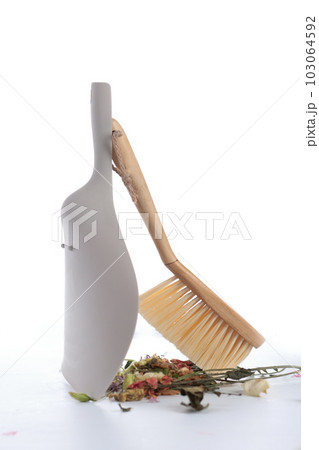 House cleaning. A dustpan and a dusting brush. Tools for cleaning the house. Garbage is collected in a heap. Photo on white background. The concept of cleanliness. Vertical photo. House cleaning. A dustpan and a dusting brush. Tools for cleaning the house. Garbage is collected in a heap. Photo on white background. The concept of cleanliness. Vertical photo. 103064592