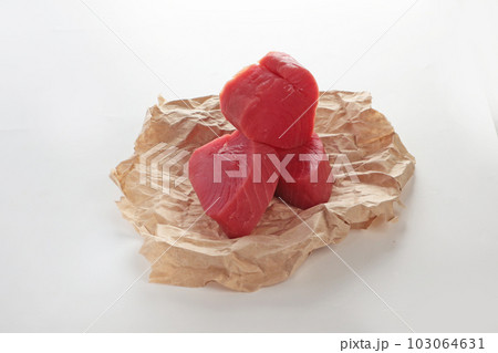 Tuna pieces for steaks on craft paper. Isolated object. Photo on white background.Isolated object. Copy space. Tuna pieces for steaks on craft paper. Isolated object. Photo on white background.Isolated object. Copy space. 103064631