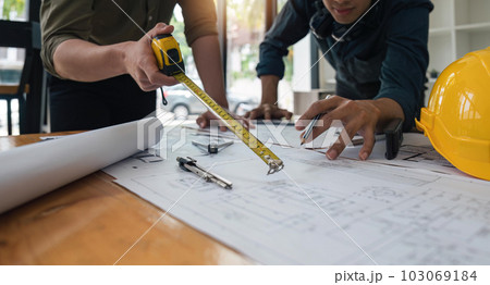 Construction concept of meeting engineers or architects for projects working with partners and engineering tools on modeling and blueprint design in office 103069184