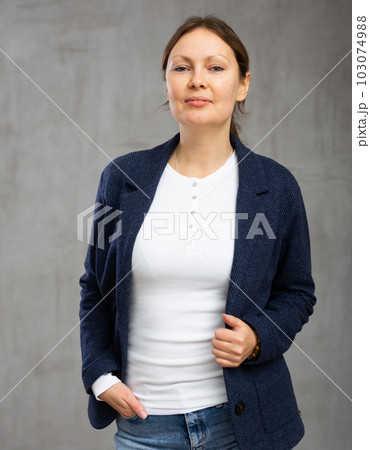 Smiling adult woman posing in jacket 103074988