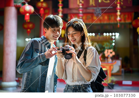 A tourist couple enjoying their old town sightseeing, taking photos and visiting a Chinese temple 103077330