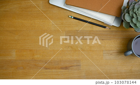 Workspace top view with stationery and copy space on wooden background. Workspace top view with stationery and copy space on wooden background. 103078144