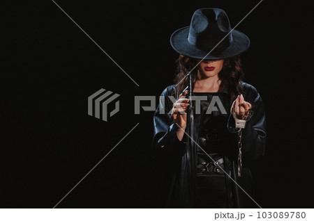 dominant woman with a leather whip flogger and handcuffs for BDSM sex with submission and domination dominant woman with a leather whip flogger and handcuffs for BDSM sex with submission and domination 103089780