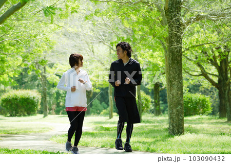 公園でランニングをする若いカップル 103090432