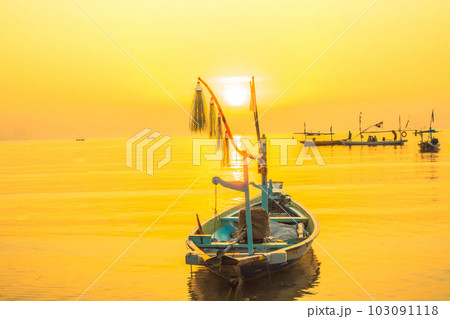 Moored boats during sunrise with yellow sky in Kenjeran, Surabaya, Indonesia. Moored boats during sunrise with yellow sky in Kenjeran, Surabaya, Indonesia. 103091118