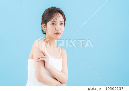 ブルーバックでスキンケアをする若い女性 ブルーバックでスキンケアをする若い女性 103091374