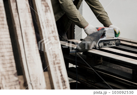 worker with belt sander 103092530