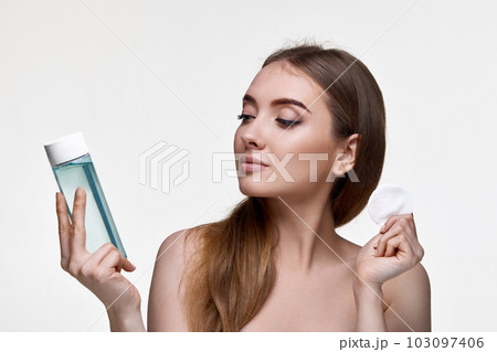 beautiful young woman holding bottle with tonic 103097406