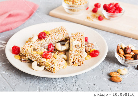 Various granola bars on table background. Cereal granola bars. Superfood breakfast bars with oats, nuts and berries, close up. Superfood concept 103098116