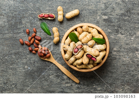 Fresh healthy peanuts in bowl on colored table background. Top view Healthy eating bertholletia concept. Super foods 103098163