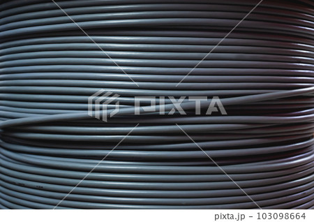 Close-up of a cable bay. Coiled cable in a polymer winding in a storage warehouse of a manufacturing enterprise. 103098664