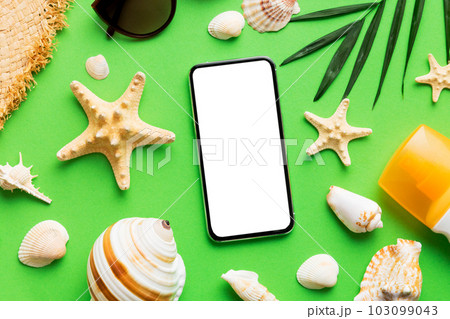 Flat lay composition with Phone and beach accessories on colored background. Smartphone with blank screen mock up with copy space 103099043