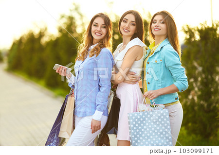 Beautiful girls with packages after shopping. Girl walking around city after shopping. good mood. Beautiful girls with packages after shopping. Girl walking around city after shopping. good mood. 103099171