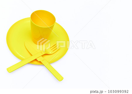 Plastic yellow knife, forks, cup, plate for camping, isolated on white Plastic yellow knife, forks, cup, plate for camping, isolated on white 103099392