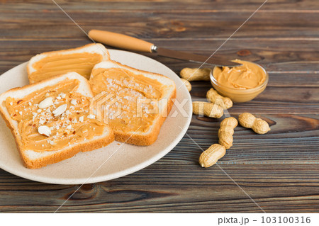 Peanut butter sandwiches or toasts on light table background.Breakfast. Vegetarian food. American cuisine top view vith copy space Peanut butter sandwiches or toasts on light table background.Breakfast. Vegetarian food. American cuisine top view vith copy space 103100316