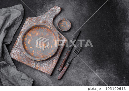 Empty wooden plate, knife, fork and cutting board Empty wooden plate, knife, fork and cutting board 103100618