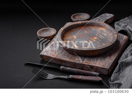 Empty wooden plate, knife, fork and cutting board Empty wooden plate, knife, fork and cutting board 103100630