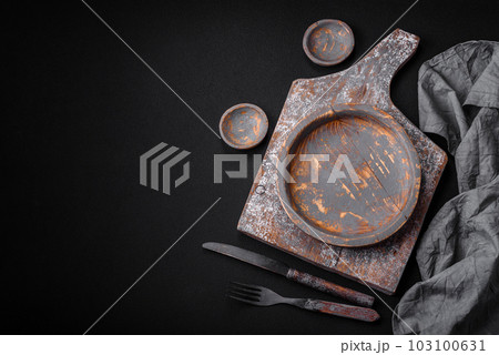 Empty wooden plate, knife, fork and cutting board 103100631