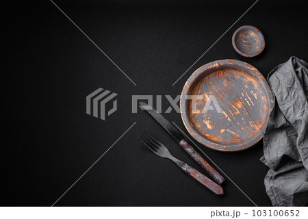 Empty wooden plate, knife, fork and cutting board 103100652