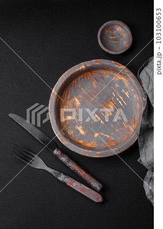 Empty wooden plate, knife, fork and cutting board Empty wooden plate, knife, fork and cutting board 103100653