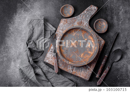 Empty wooden plate, knife, fork and cutting board Empty wooden plate, knife, fork and cutting board 103100715