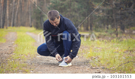 Runner tying shoelaces on sneakers. 103101553