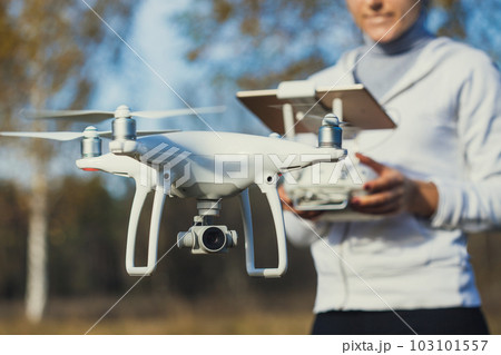 Flying the copter. Remote control in a women's hands Flying the copter. Remote control in a women's hands 103101557