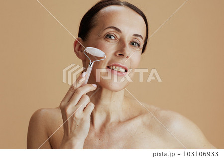 Portrait of happy modern woman on beige background Portrait of happy modern woman on beige background 103106933