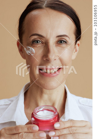 Portrait of happy modern woman in white shirt isolated on beige 103106955