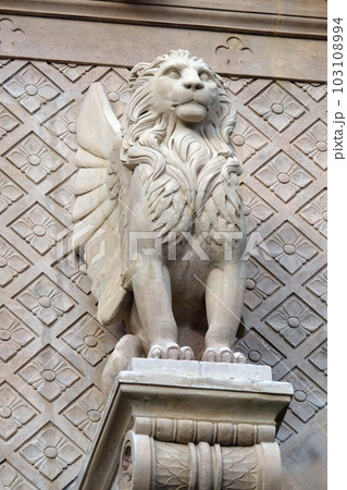 The winged Lion symbol of St. Mark the Evangelist, statue on the facade of Saint Augustine church in Paris, France 103108994