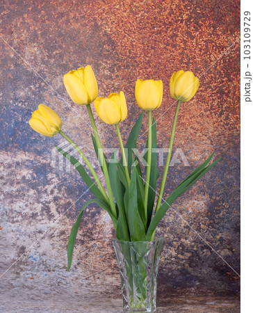 Beautiful bouquet of yellow blooming tulips in a crystal vase. Beautiful bouquet of yellow blooming tulips in a crystal vase. 103109729