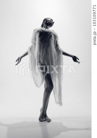 Portrait with silhouette of beautiful young girl with perfect body shape posing covered wet, transparent fabric over pastel background. Venus 103109771