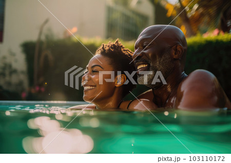 Mixed race middle age couple enjoying time in pool Mixed race middle age couple enjoying time in pool 103110172