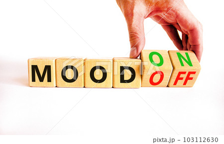Mood on or off symbol. Businessman turns wooden cubes and changes word Mood off to Mood on. Beautiful white table white background. Business and mood on or off concept. Copy space. Mood on or off symbol. Businessman turns wooden cubes and changes word Mood off to Mood on. Beautiful white table white background. Business and mood on or off concept. Copy space. 103112630