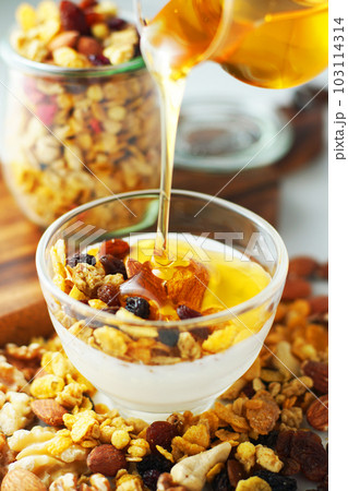 ヨーグルトにグラノーラをのせて蜂蜜をかける。 103114314