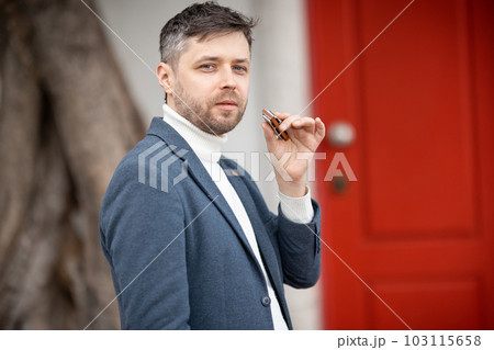 Adult man with harmonica - looking at the camera 103115658