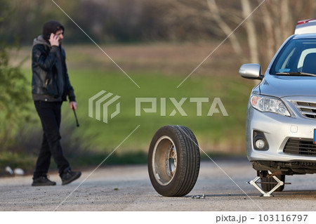 Tire change problems on the road, phona call for help 103116797