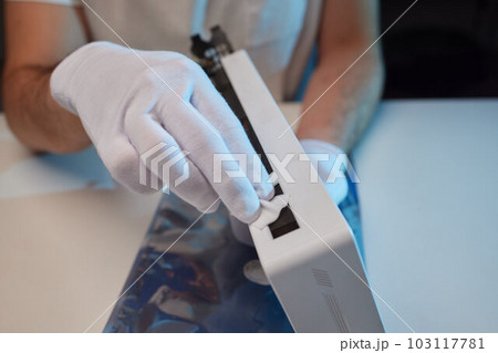 Changing the thermal paste on the graphics processor. Disassembled graphics card on the table. Old graphics card service. Changing the thermal paste on the graphics processor. Disassembled graphics card on the table. Old graphics card service. 103117781