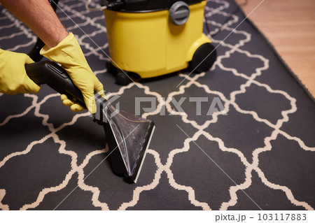 Close-up Of A Person Cleaning Carpet With Vacuum Cleaner. 103117883