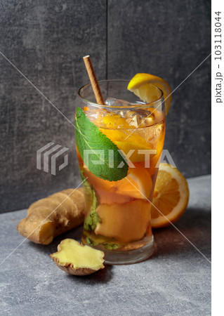 Iced tea with mint, ginger, and lemon on a grey background. 103118044
